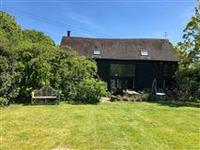 A FIVE-BEDROOM BARN CONVERSION WITH PLENTY OF CHARACTER AND DELIGHTFUL GARDENS