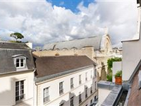 THIS BRIGHT SPLIT-LEVEL APARTMENT ENJOYS A LOVELY OPEN VIEW
