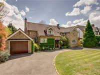 THIS FINE HOME SITS WELL WITHIN BEAUTIFULLY LANDSCAPED MATURE GARDENS