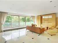 A LUXURIOUS RESIDENCE FACING THE WOODS OFFERS A WIDE SOUTH-FACING BALCONY