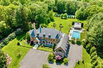 UNCOMPROMISING FRENCH NORMANDY-INSPIRED HOME ON FOUR ACRES