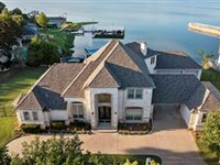 EXCEPTIONAL LAKE FRONT HOME IN SOUGHT AFTER GATED COMMUNITY OF BAY CLUB