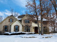 DISTINCTIVE, UNIQUE CUSTOM HOME NESTLED ON PRIVATE WOODED LAKE LOT