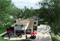 FABULOUS GATED LAKEFRONT HOME WITH PRIVATE SANDY BEACH