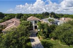 CUSTOM-BUILT LAKEFRONT HOME WITH BEAUTIFULLY LANDSCAPED COURTYARD WITH POOL