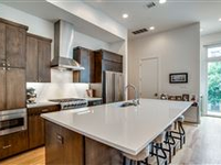 THIS BEAUTIFUL HOME OFFERS A ROOFTOP DECK WITH UNOBSTRUCTED DALLAS SKYLINE VIEWS