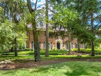 LUXURY MEET TRANQUILITY IN THIS PRIVATE WOODED ACRES PROPERTY