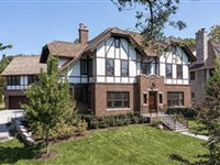 MASTERFULLY PRESENTED BRICK TUDOR REVIVAL