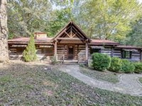 UNIQUE LOG HOUSE ON THIRTY-FIVE ACRES OF WOODED LAND