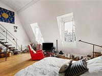THIS BRIGHT SPLIT-LEVEL APARTMENT ENJOYS A LOVELY OPEN VIEW