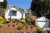 A ROSE GARDEN AND WORKING FOUNTAIN GRACE THE ENTRY TO THIS LIGHT FILLED MONTCLAIR RETREAT