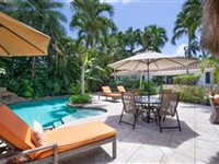 CHIC AND CHARMING HOME ON A PRIVATE AND TROPICALLY LANDSCAPED CORNER LOT